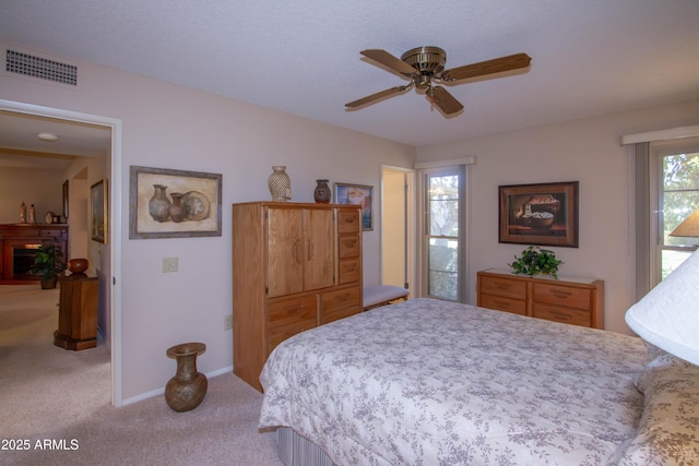 bedroom featuring a textured ceiling, ceiling fan, and carpet