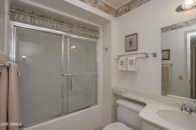 full bathroom featuring toilet, vanity, and shower / bath combination with glass door