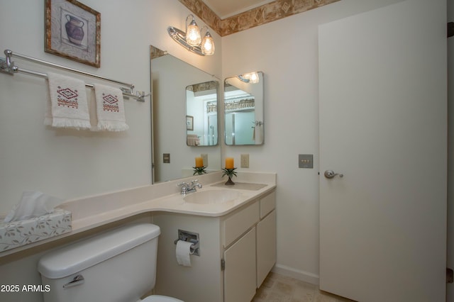 bathroom featuring toilet and vanity