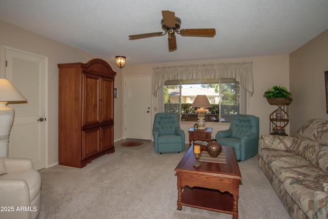 living room featuring a textured ceiling, ceiling fan, and light colored carpet