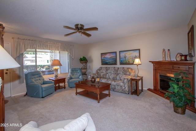 living room featuring ceiling fan, a textured ceiling, and light carpet