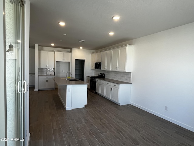 kitchen featuring decorative backsplash, a kitchen island with sink, black appliances, white cabinets, and dark hardwood / wood-style floors