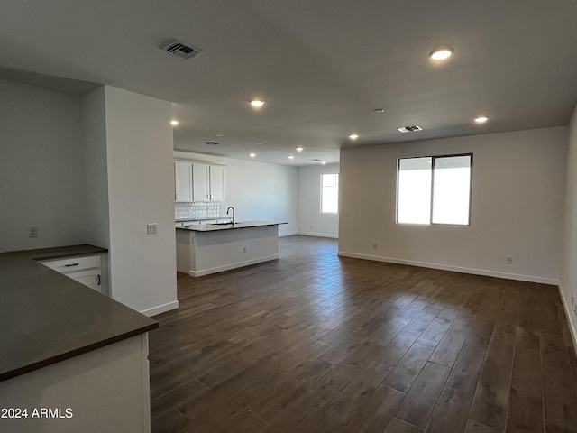 unfurnished living room featuring dark hardwood / wood-style flooring