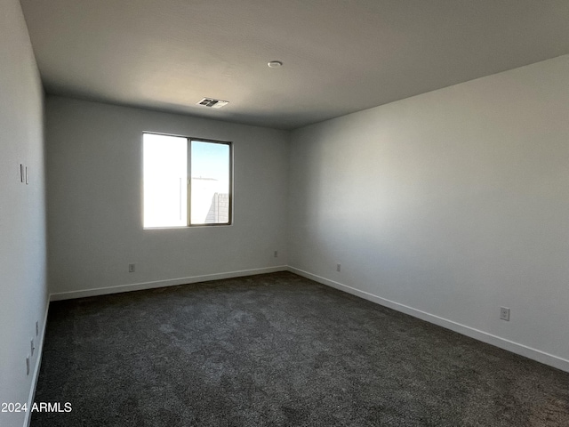 empty room with dark carpet