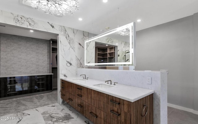 bathroom featuring recessed lighting, a sink, and double vanity