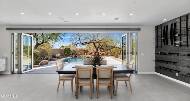 dining area with baseboards and recessed lighting