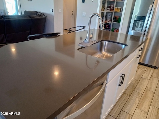 kitchen with sink, stainless steel appliances, and white cabinets