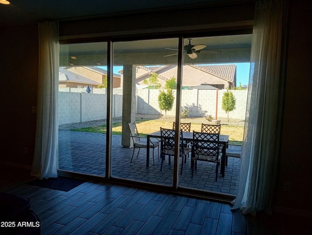 doorway with ceiling fan