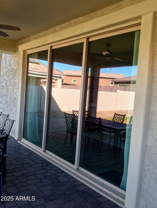 exterior space featuring ceiling fan