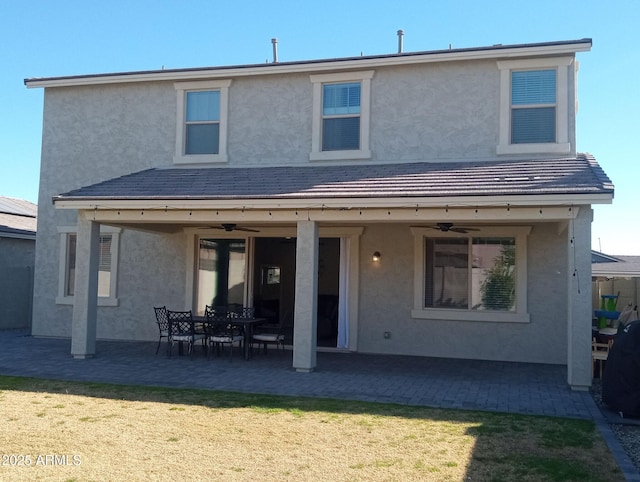 back of house featuring a patio area, ceiling fan, and a lawn