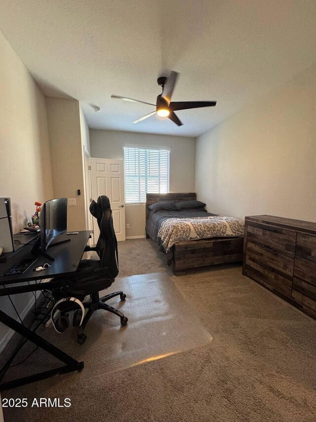 bedroom with a textured ceiling, ceiling fan, and carpet