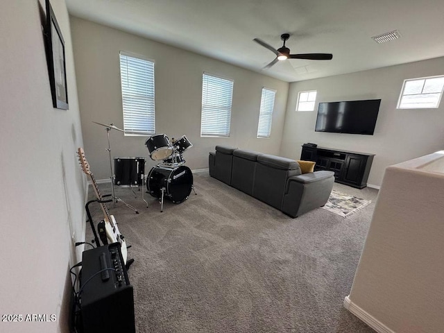 living room featuring ceiling fan, light carpet, and plenty of natural light