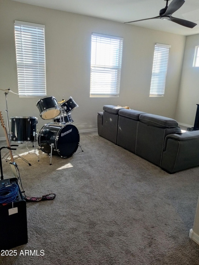 interior space featuring carpet floors, ceiling fan, and a wealth of natural light