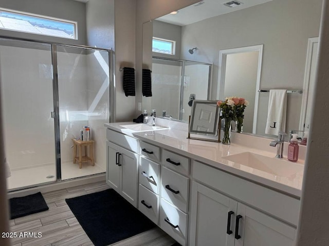 bathroom with an enclosed shower and vanity