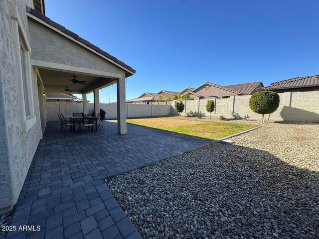 view of yard featuring a patio area and ceiling fan