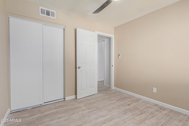 unfurnished bedroom featuring a closet, ceiling fan, and light hardwood / wood-style flooring