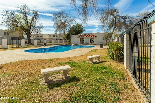 view of pool with a yard and a patio