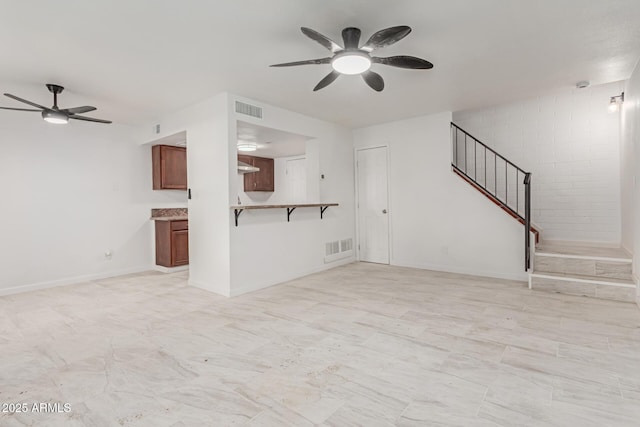 unfurnished living room with ceiling fan