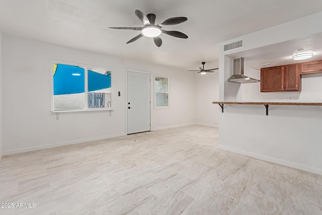 unfurnished living room featuring ceiling fan