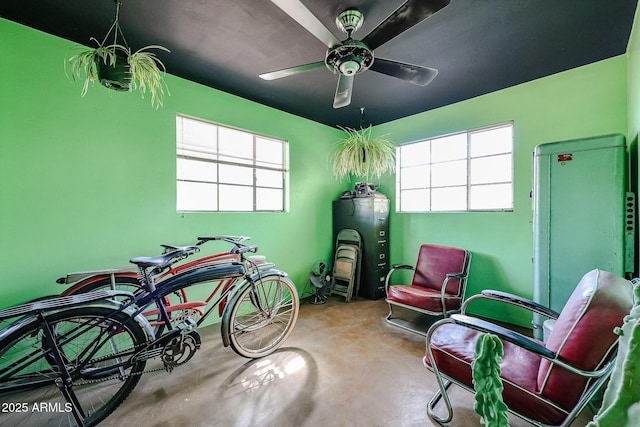 miscellaneous room with concrete flooring and a ceiling fan