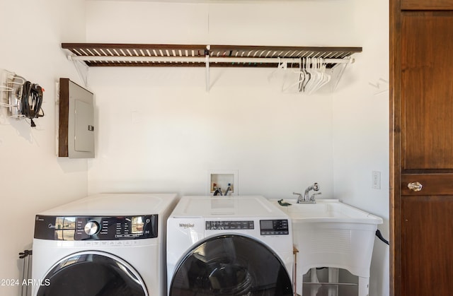 laundry room featuring independent washer and dryer, electric panel, and sink