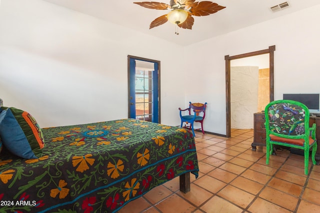 bedroom with tile patterned floors and ceiling fan