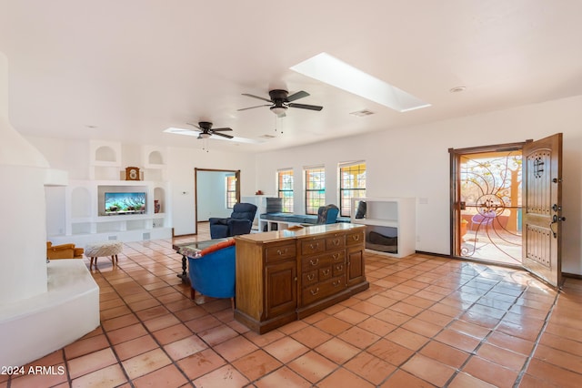 tiled living room with a skylight, ceiling fan, and built in features