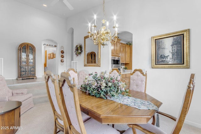 carpeted dining room featuring a notable chandelier