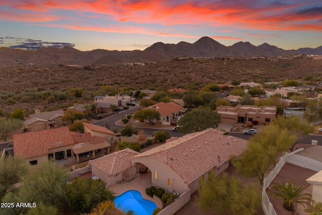 aerial view at dusk featuring a mountain view