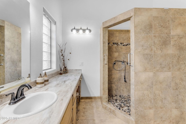 bathroom with vanity, tile patterned floors, and tiled shower