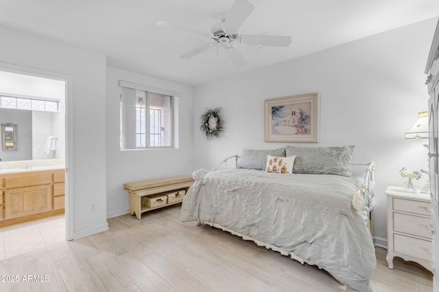 bedroom featuring ensuite bath, ceiling fan, sink, and light hardwood / wood-style flooring