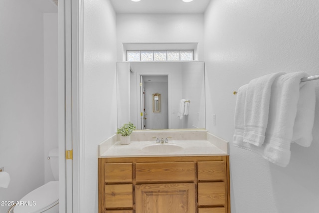 bathroom featuring toilet and vanity