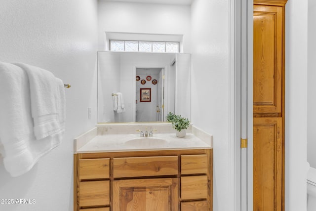 bathroom with toilet and vanity