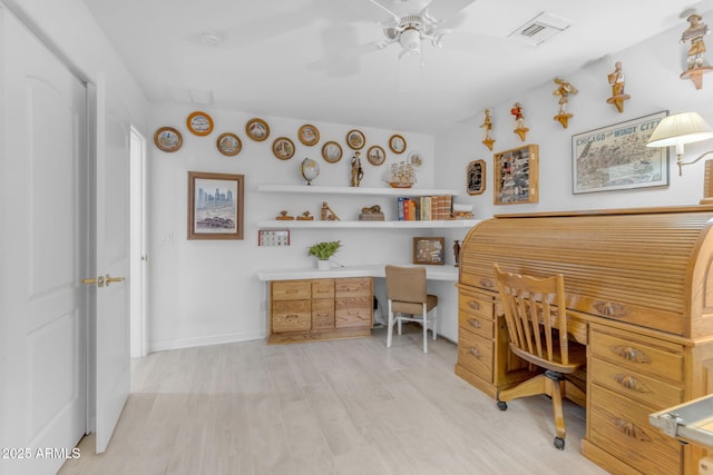 office area with built in desk, ceiling fan, and light hardwood / wood-style floors