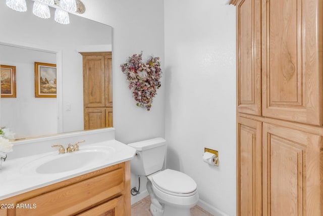 bathroom with toilet and vanity