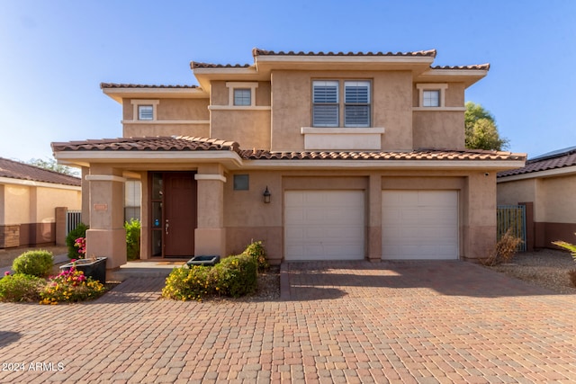 mediterranean / spanish home with a garage