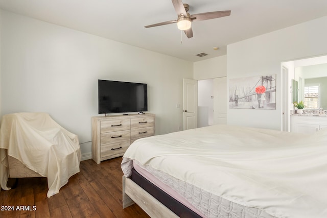 bedroom with ensuite bath, ceiling fan, and dark hardwood / wood-style floors