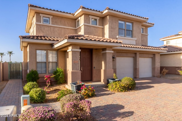 mediterranean / spanish home featuring a garage