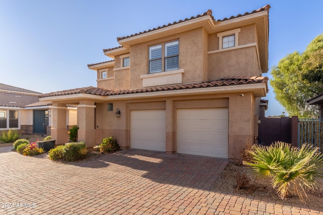 mediterranean / spanish house with a garage