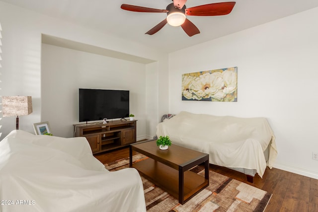 living room featuring dark hardwood / wood-style floors and ceiling fan