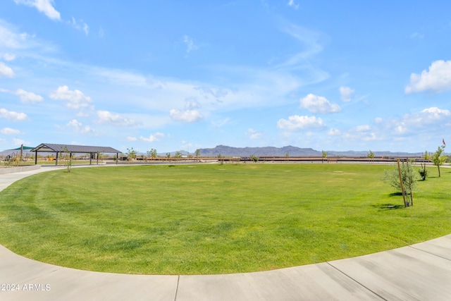 view of community with a mountain view, a gazebo, and a lawn