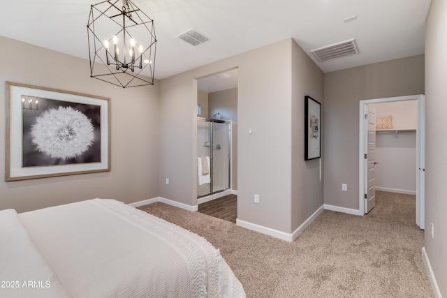 10619 W Bloch Rd, Tolleson, AZ 85353 - carpeted bedroom with a chandelier, a spacious closet, and connected bathroom