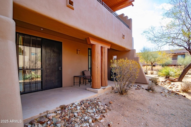 view of exterior entry featuring a patio area