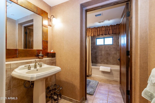 bathroom with shower / bathtub combination with curtain and tile patterned floors