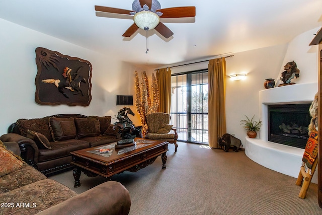 carpeted living room with ceiling fan