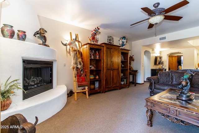 living room featuring ceiling fan and carpet