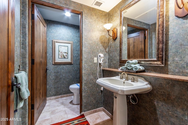 bathroom featuring tile patterned flooring and toilet