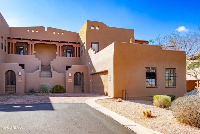 southwest-style home featuring a garage