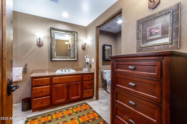 bathroom with tile patterned floors, vanity, and toilet