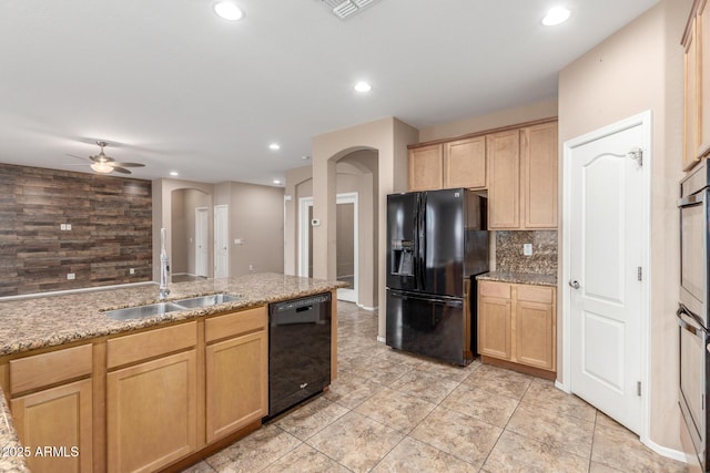 kitchen with light brown cabinetry, sink, backsplash, and black appliances